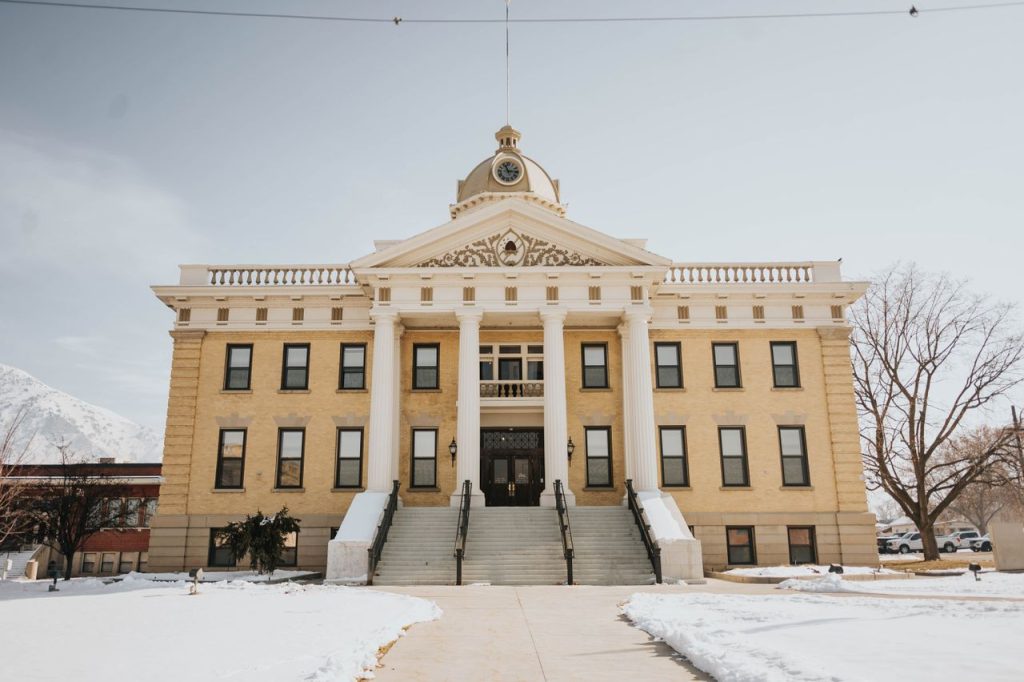 A prominent historic building in Brigham City, Utah, covered in snow during winter.